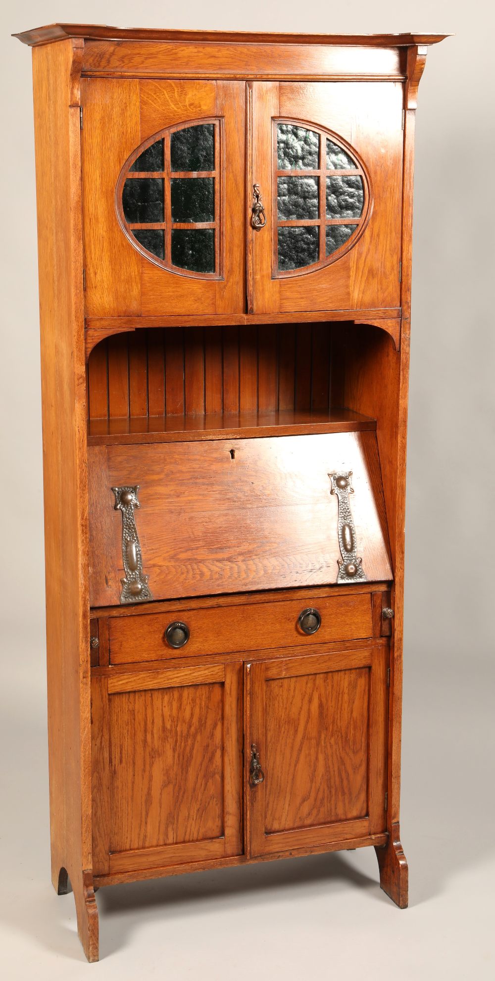 Arts and crafts oak bureau bookcase, with copped stylized mounts, green glazed top cupboard, 179 x