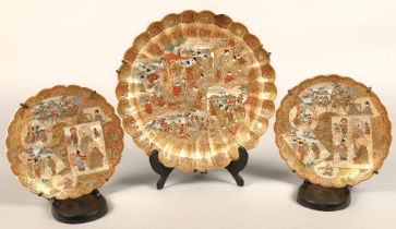 Pair of satsuma scalloped edge plates, each with panels of figures, with a larger scalloped edge