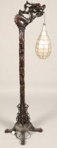 Oriental style carved hardwood free standing lamp in the form of a dragon, with droplet leaded lamp,