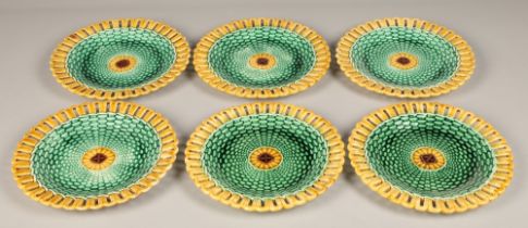 Seven piece Wedgwood majolica fruit set, with green lustre weave effect with yellow pierced border.