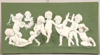Wedgwood style porcelain wall plaque, depicting putti, 32.5 long, 18cm high.