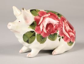 Wemyss ware pig, hand painted with cabbage rose decoration, 16cm long.