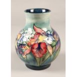 Moorcroft pottery vase in the Orchid pattern, 20cm high.