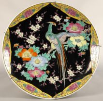 Japanese porcelain charger, black ground with bird and foliate decoration, 46cm diameter.