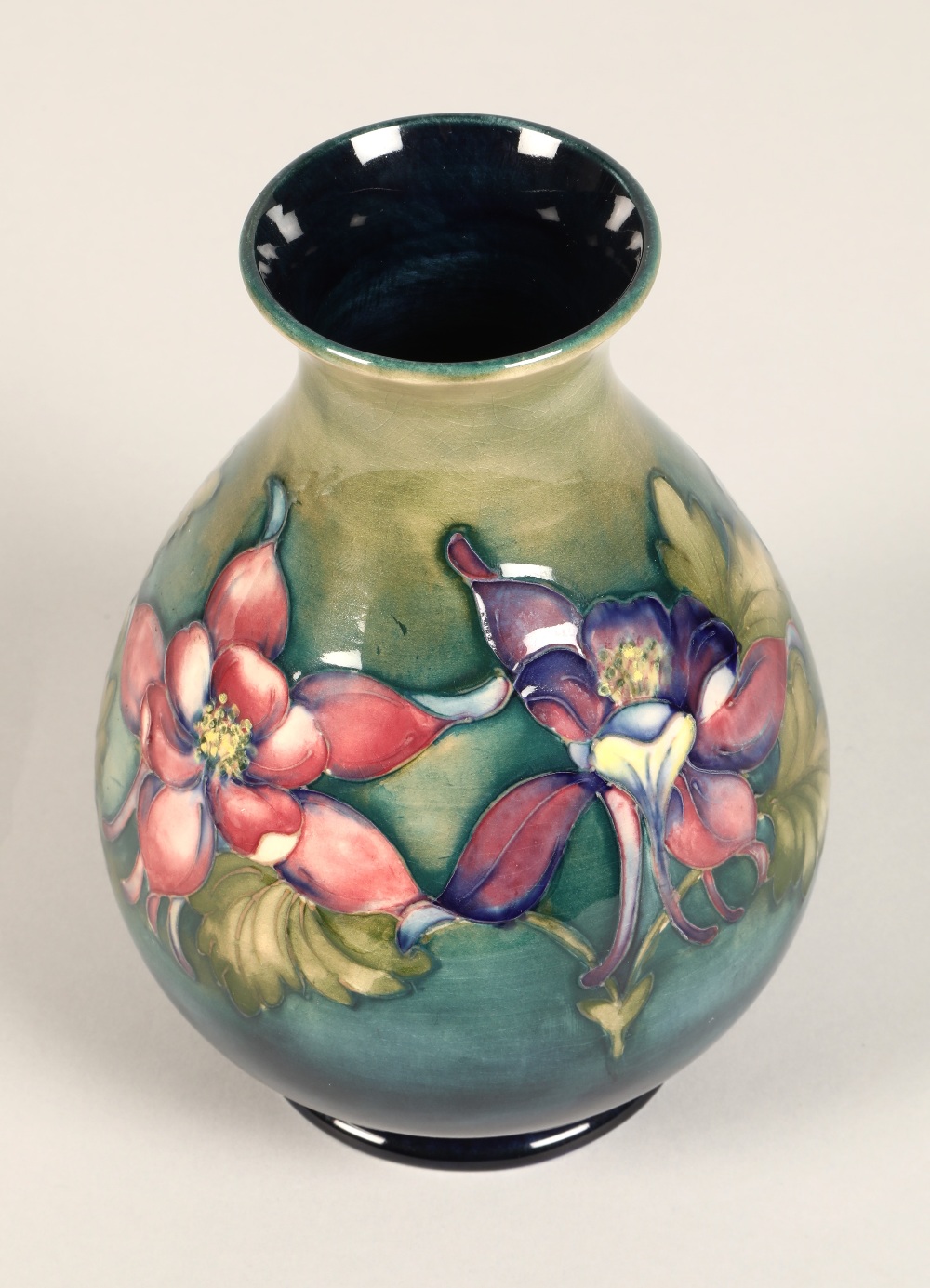 Moorcroft pottery vase of baluster form, green/blue ground in the clematis pattern, signed in blue - Image 6 of 13