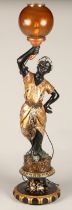 Blackamoor figure converted in to a lamp, depicting a lady in golden robes holding a lamp, 97 cm