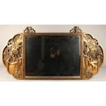 Oriental wall mirror, decorated in relief with ladies in garden  on brass mounts 112 x 51 cm