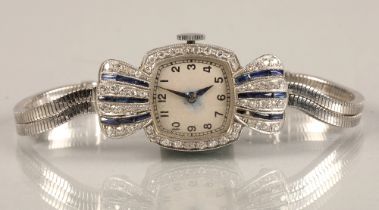 Ladies platinum and sapphire cocktail watch, numbered dial surrounded by small diamonds, with four