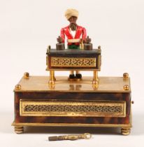 A 19th century Little Conjurer Musical Automaton, in the form of a small bearded man standing behind