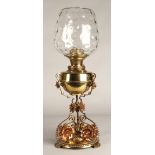 Oil lamp with copper and brass foliate decoration on the base, 62 cm high including glass shade