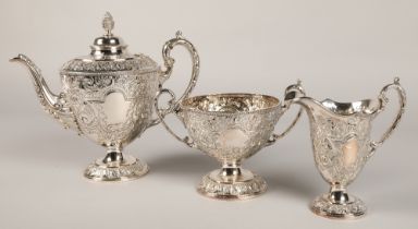 Three piece silver plated tea service with embossed decoration.