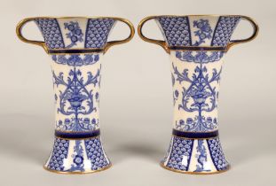 Pair of MacIntyre vases, flared form with looped handles, blue and white floral design, factory