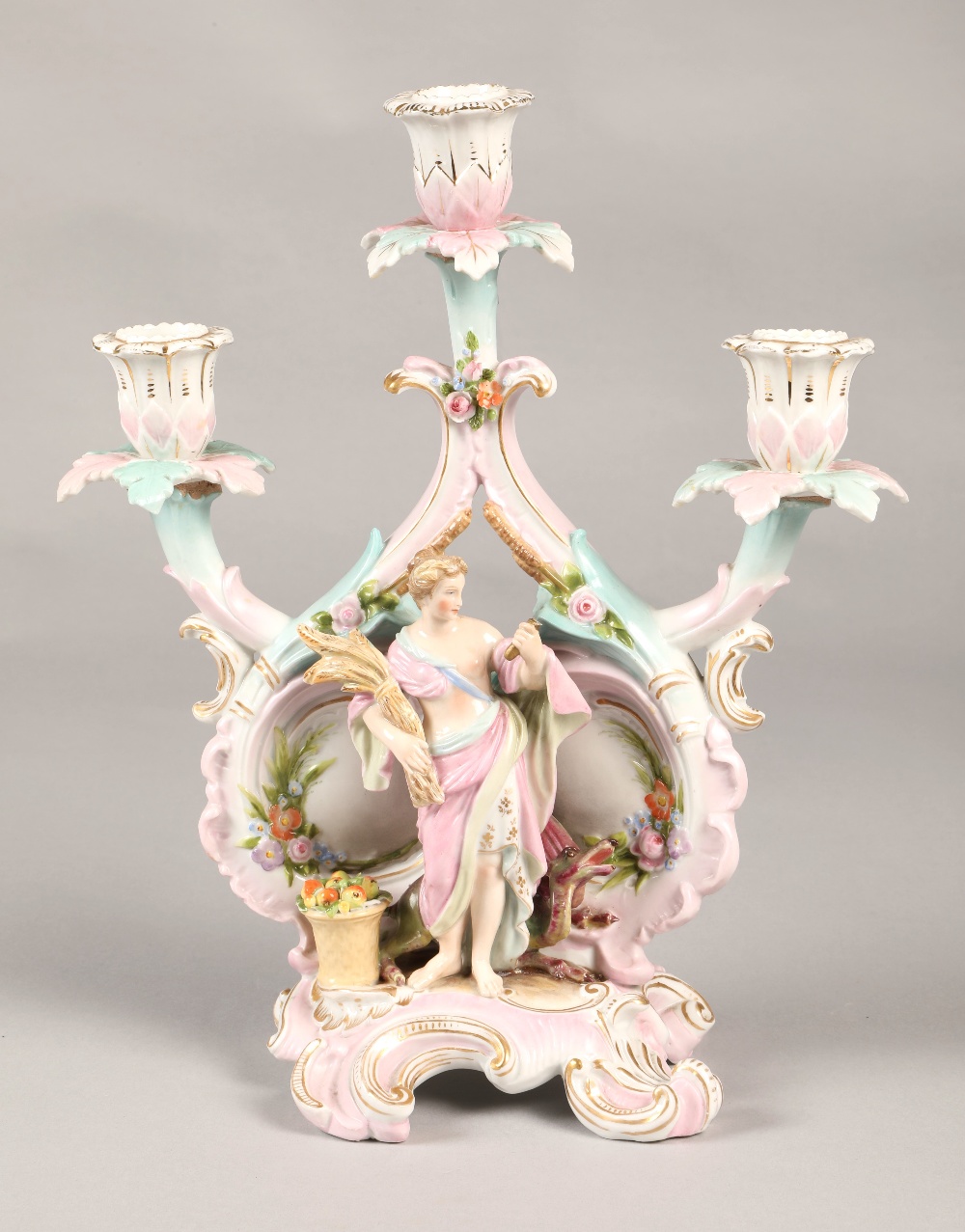 Meissen style candelabra with cross sword markings, featuring a classical figure holding wheat