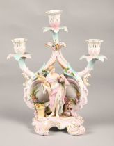 Meissen style candelabra with cross sword markings, featuring a classical figure holding wheat