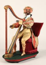 An antique musical automaton in the form of a seated monkey harp player, being a variation on number