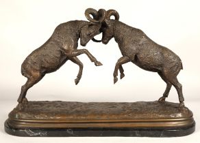 Twentieth century figure of two rams fighting on marble base, signed T R, 75cm long, 47cm high