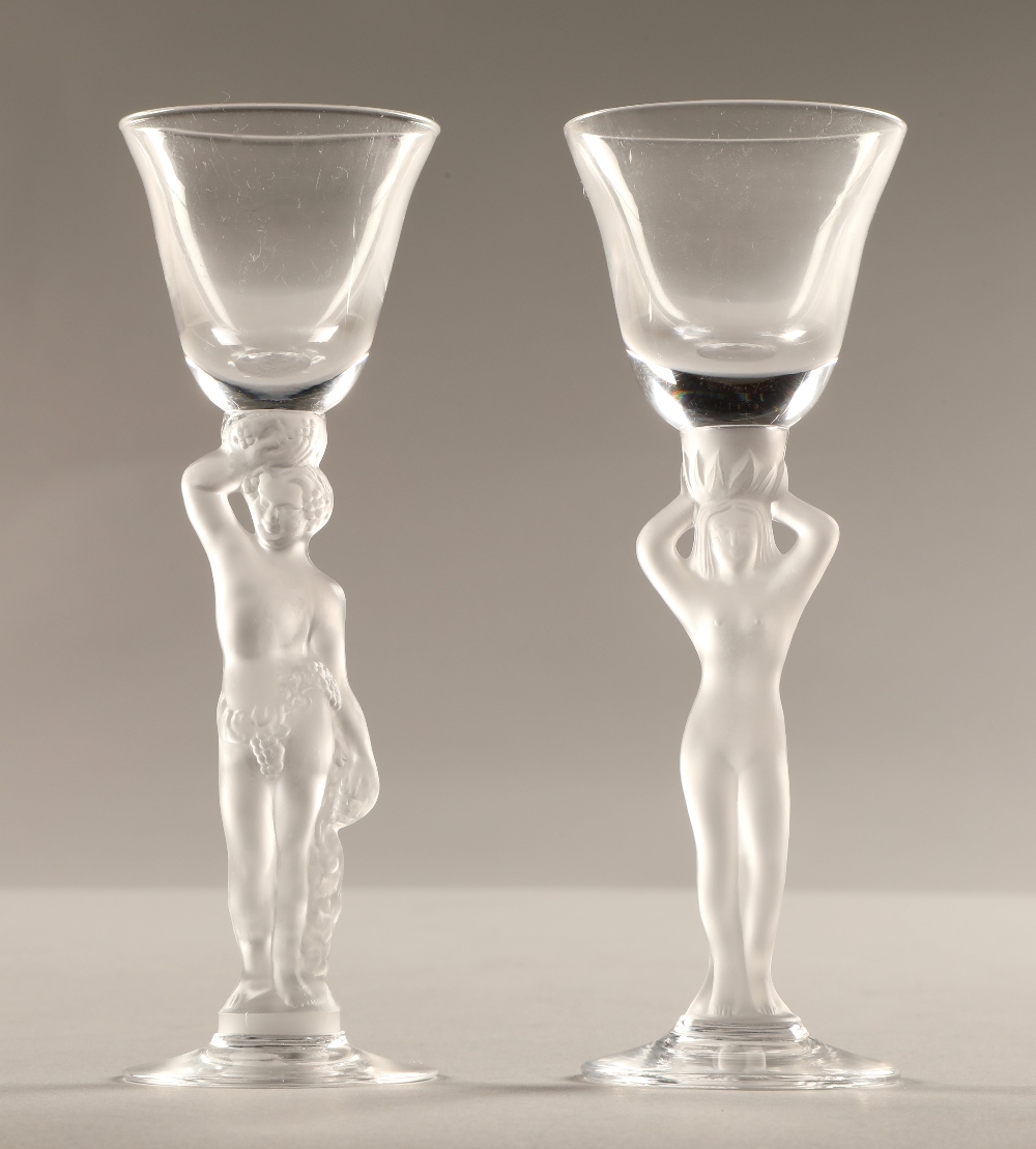 Pair of glasses with frosted figure stems, 15cm high.