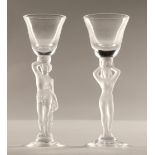 Pair of glasses with frosted figure stems, 15cm high.