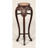 Chinese carved hardwood jardiniere stand, with rouge marble insert, with carved apron and under