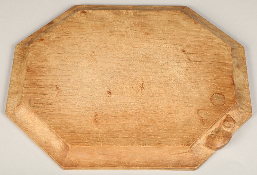 Robert Thompson of Kilburn, (1876-1955), a "Mouseman" carved oak breadboard,30.5cm x 25.5cm.