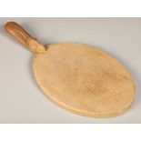 Robert Thompson of Kilburn (1876-1955), "Mouseman", carved oak cheese board with short handle,