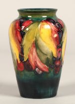 Moorcroft pottery vase of baluster form decorated in the leaf & berry pattern, 13cm high.