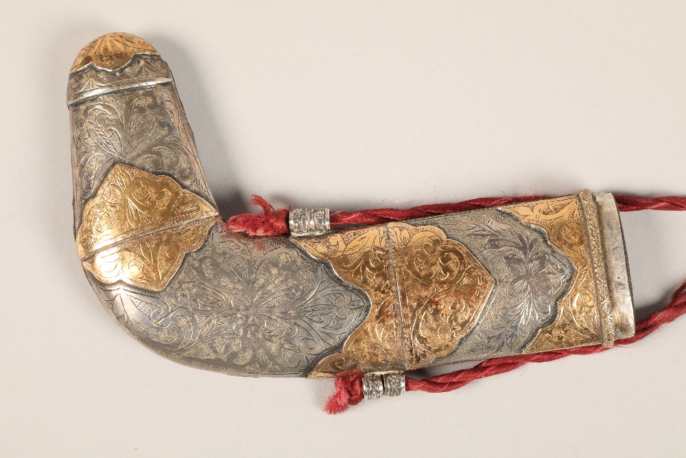A Middle Eastern Omani white metal mounted Jambiya dagger, with gilt enrichments and engraved - Image 4 of 4