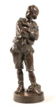 After Anton Nelson (French 1880-1910) 'Defi' bronze figure of a boy with arms crossed and cap,