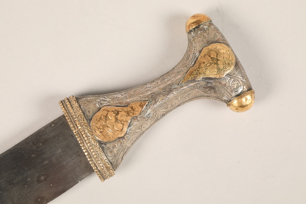 A Middle Eastern Omani white metal mounted Jambiya dagger, with gilt enrichments and engraved - Image 2 of 4