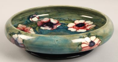 Moorcroft shallow pottery bowl in the anemone pattern on blue and green ground, impressed marks