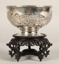 Chinese embossed silver bowl, embossed with flowering prunus, raised on a circular base, maker