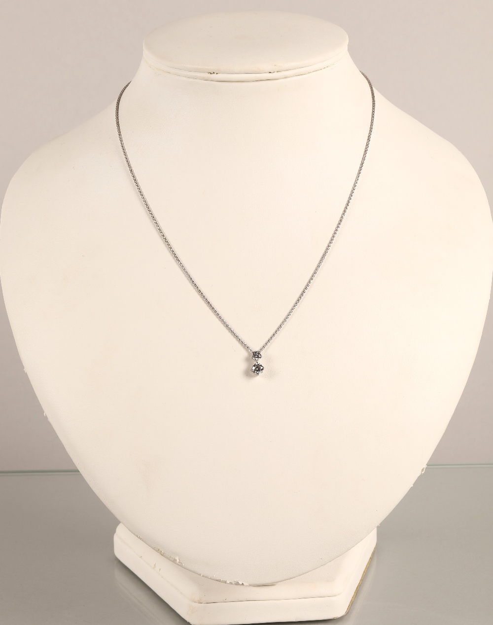 Ladies two stone diamond pendant mounted on an 18ct white gold chain. stone one 0.5 carat, stone two
