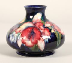 Moorcroft pottery vase, of squat form, blue ground in the iris pattern, impressed mark with blue