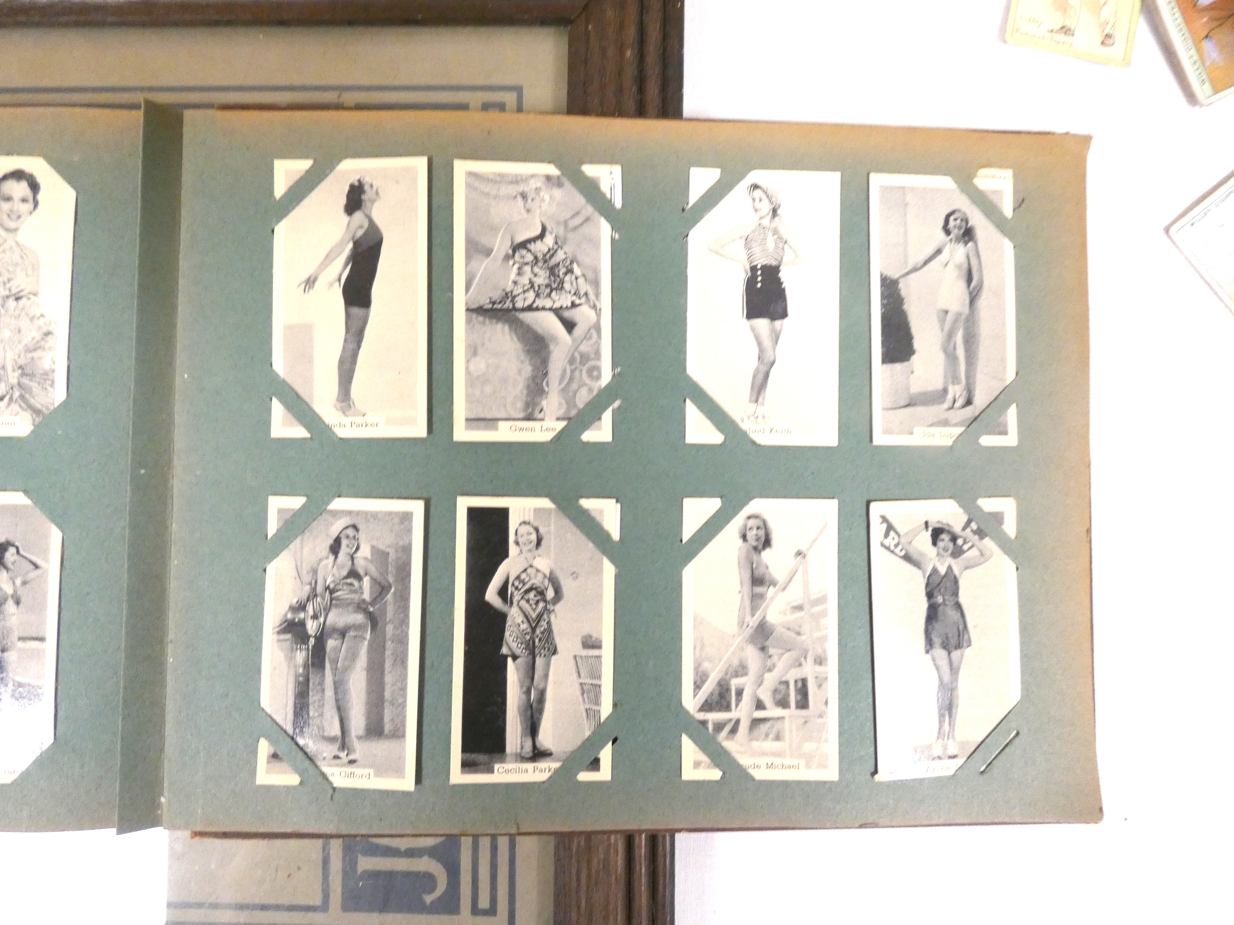 Cigarette Cards.  Framed set of Player's cards of 1936 Coronation costume; an album of loose mounted