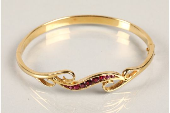 18ct yellow gold stiff bangle set with nine graduated rubies, 6cm diameter, 19.8 grams. - Image 3 of 3