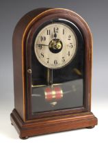 A Bulle electric mantel clock, early 20th century, the arched mahogany case with glazed door