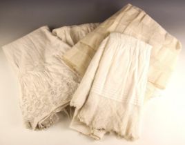 Five mid-Victorian cotton petticoats, each variously trimmed with broderie Anglaise, together with a