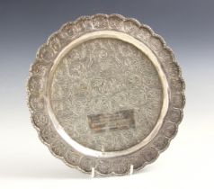 ROYAL INTEREST: A silver coloured presentation salver, the shaped rim with circular embossed