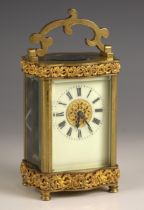 A French eight day brass cased carriage timepiece, late 19th century, the case of serpentine form