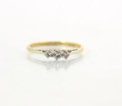 An Edwardian style three stone diamond ring, the central round cut diamond with smaller diamond to