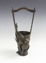 A Japanese bronze Ikebana vase, Meiji Period (1868-1912), modelled as a handled cache pot with a