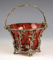 A white metal mounted ruby glass sugar basket, 19th century, the pierced gallery designed as springs