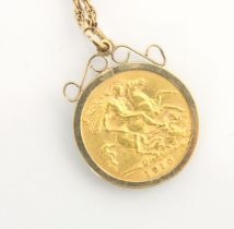 An Edwardian half sovereign, dated 1910, within a 9ct yellow gold mount, upon an associated yellow