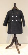 A green Harris Tweed child's coat, retailed by Harrods, with double breast and abalone buttons,