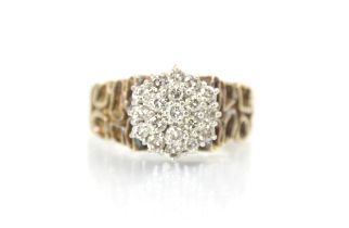 An 18ct yellow gold diamond cluster ring, the raised diamond set cluster within claw set white metal