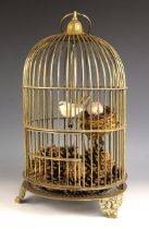 An Edwardian lacquered brass bird cage, of typical domed form raised on spandrel feet, the