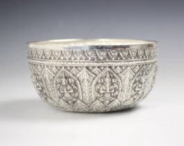 A Burmese silver coloured bowl, the ten repeating embossed panels depicting deities among