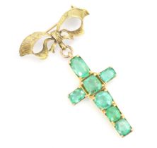 A 20th century emerald set cross pendant/brooch, the mixed cut emeralds within yellow metal claw set