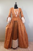 A fine light bronze brocaded silk robe a la anglaise, circa 1760, with pinked ruffles to sleeves and