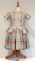 An 1840's boys fine wool tartan dress, the bodice, peplum and sleeves edged with soutache braid